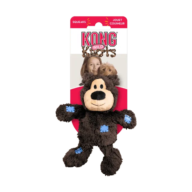 KONG Wild Knots Dark Brown Bear Plush Dog Toy in original retail packaging, featuring a squeaker and internal knotted rope.