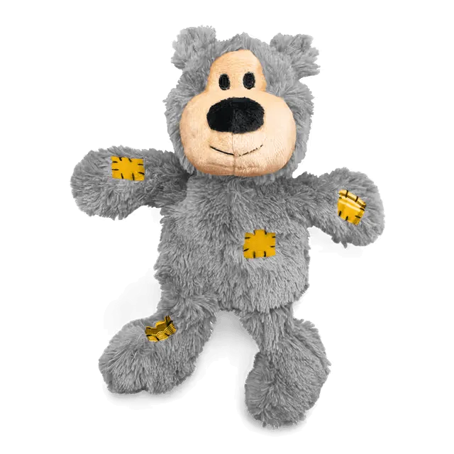 KONG Wild Knots Grey Bear Plush Dog Toy featuring soft grey fur, yellow stitched patches and a durable internal rope skeleton.