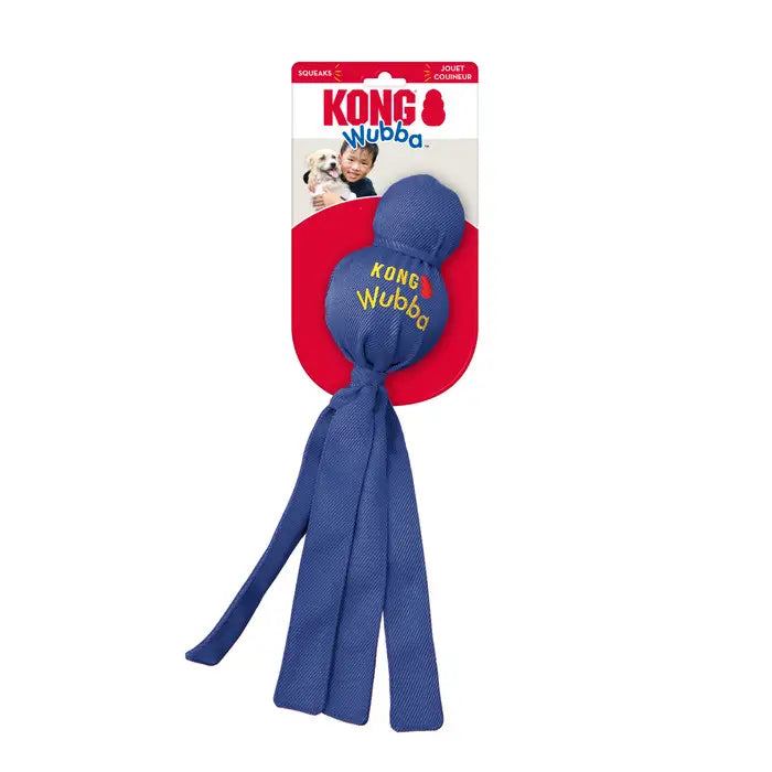 Blue KONG Wubba dog toy in original KONG packaging, featuring reinforced nylon fabric, two ball-shaped sections and long tails for interactive play.